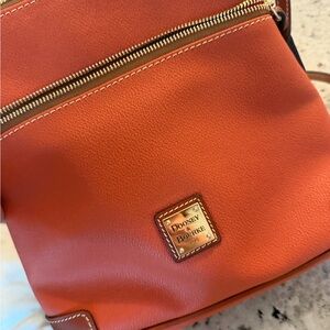 Dooney & Bourke brand new  Orange pebbled Leather Crossbody with Gold Plate